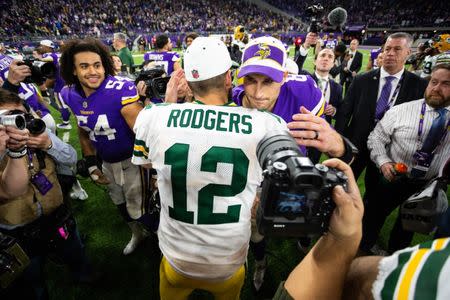 Nov 25, 2018; Minneapolis, MN, USA; Green Bay Packers quarterback Aaron Rodgers (12) and Minnesota Vikings quarterback Kirk Cousins (8) hug after the game at U.S. Bank Stadium. Mandatory Credit: Harrison Barden-USA TODAY Sports