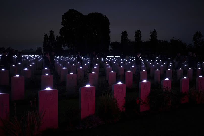 Candles are lit on each tombstone of the Commonwealth war cemetery in Normandy, France, June 4, 2024. 