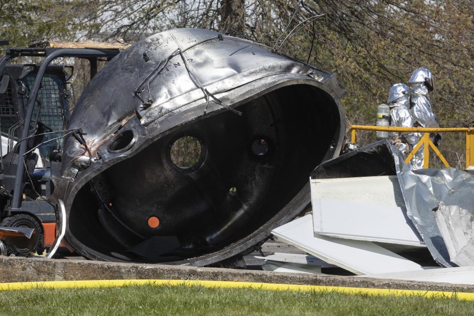 Firefighters watch as crews remove chemicals from the Seqens/PCI Synthesis pharmaceutical plant, Friday, May 5, 2023, in Newburyport, Mass. The plant where a powerful blast killed a Massachusetts worker on Thursday has moved into the cleanup phase. (AP Photo/Michael Dwyer)