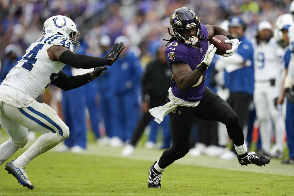 Sep 24, 2023; Baltimore, Maryland, USA; Baltimore Ravens running back Melvin Gordon III (33) runs with the football while being defended by Indianapolis Colts linebacker Zaire Franklin (44) in the second half at M&T Bank Stadium. Mandatory Credit: Brent Skeen-USA TODAY Sports