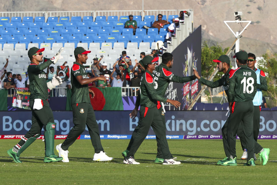 Bangladesh players celebrate the dismissal of Papua New Guinea's Charles Amini during the Cricket Twenty20 World Cup match between Bangladesh and Papua New Guinea in Muscat, Oman, Thursday, Oct. 21, 2021. (AP Photo/Kamran Jebreili)