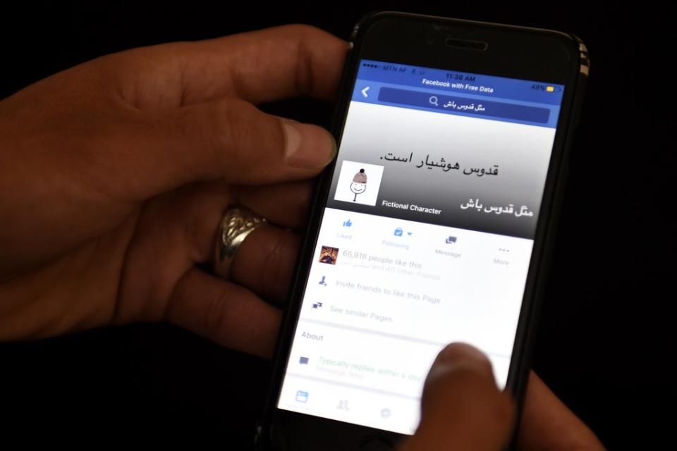 An Afghan university student looks at a meme on a Facebook account in Kabul on January 30 2016 (AFP via Getty Images)