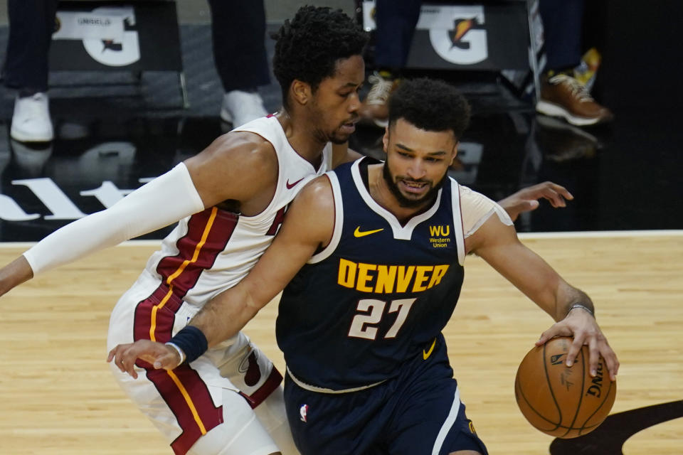 Miami Heat forward KZ Okpala (4) guards Denver Nuggets guard Jamal Murray (27) as he drives to the basket during the first half of an NBA basketball game, Wednesday, Jan. 27, 2021, in Miami. (AP Photo/Marta Lavandier)