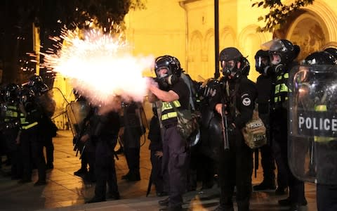 Riot police cracked down on the protest with tear gas, rubber bullets and a water cannon - Credit: Irakli Gedenidze/Reuters