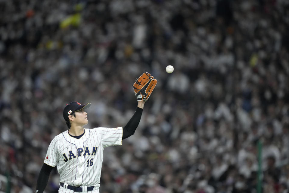 Japane's starting pitcher Shohei Ohtani receives the ball from Japan's catcher Takuya Kai during the fourth inning of the quarterfinal game between Italy and Japan at the World Baseball Classic (WBC) at Tokyo Dome in Tokyo, Japan, Thursday, March 16, 2023. (AP Photo/Eugene Hoshiko)