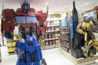 In this Tuesday, Nov. 13, 2018 photo, a Transformer robot is on display during a media preview of the new FAO Schwarz store at Rockefeller Center in New York. A new FAO opens Friday, Nov. 16, about 10 blocks from its former home near the southeast corner of Central Park. There are a few extravagant items to be had in the new store but plenty of modestly priced items, too. (AP Photo/Mary Altaffer)