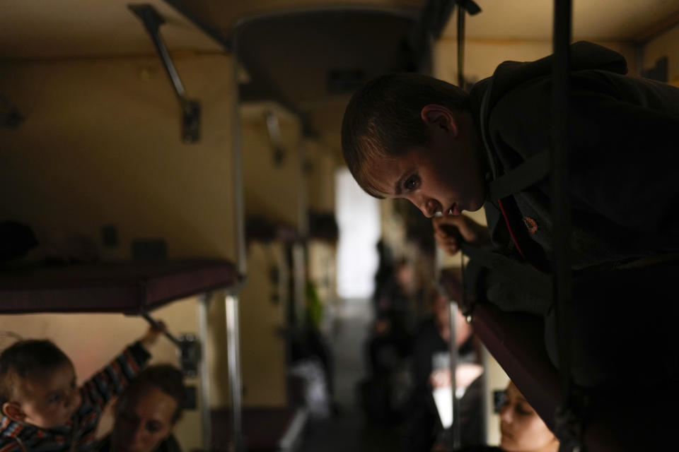 People fleeing Lysychansk sit on an evacuation train at the train station in Pokrovsk, eastern Ukraine, eastern Ukraine, Saturday, May 28, 2022. Fighting has raged around Lysychansk and neighbouring Sievierodonetsk, the last major cities under Ukrainian control in Luhansk region. (AP Photo/Francisco Seco)