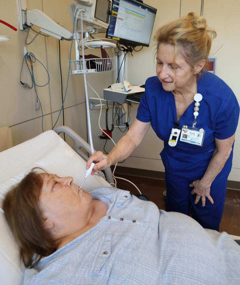 Norton LPN Karla Begue works with patient, Pam Jefferies, as she undergoes special treatment.