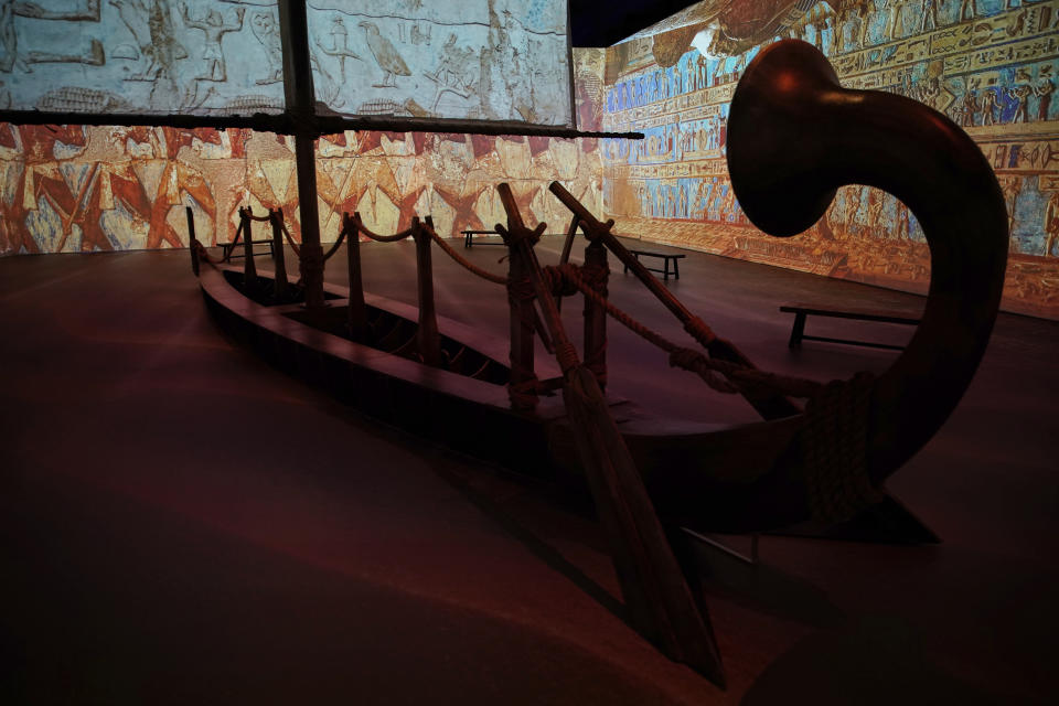 A model ancient Egyptian boat is surrounded by projections at the Beyond King Tut Immersive Experience, Thursday, Oct. 27, 2022, in New York. The exhibition will open to the public on Friday, in commemoration of the the 100th anniversary of the discovery of King Tut's tomb on Nov. 4, 1922. (AP Photo/Julia Nikhinson)