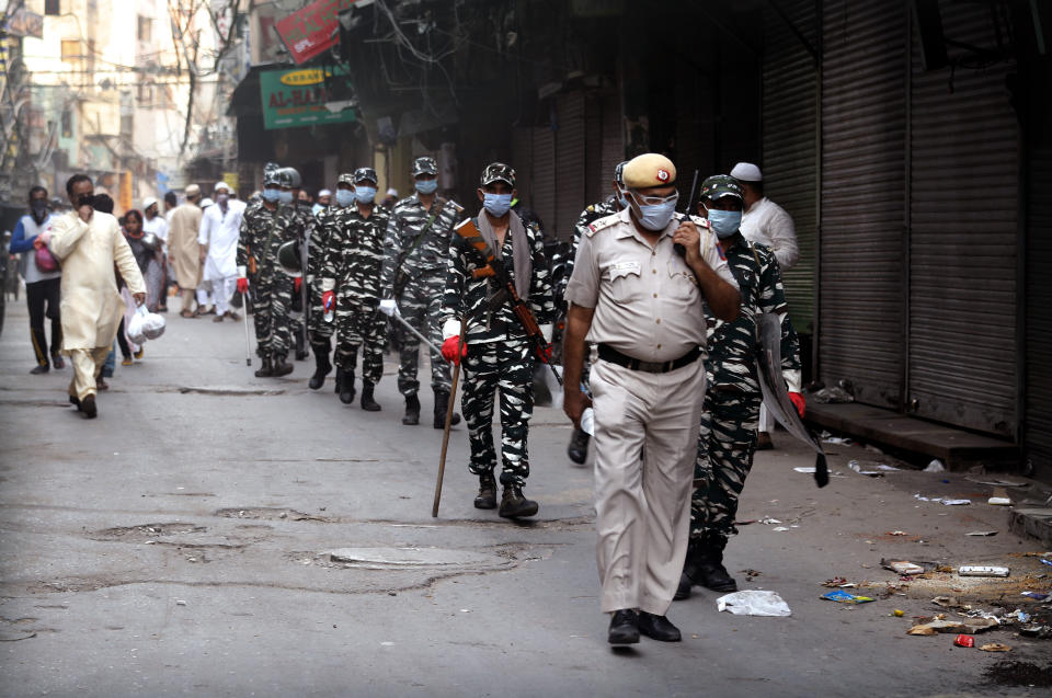 Indian policemen patrol during Eid al-Fitr near the Jama Mosque at the old quarters of New Delhi, India, Monday, May 25, 2020. The holiday of Eid al-Fitr, the end of the fasting month of Ramadan, a usually joyous three-day celebration has been significantly toned down as coronavirus cases soar. (AP Photo/Manish Swarup)