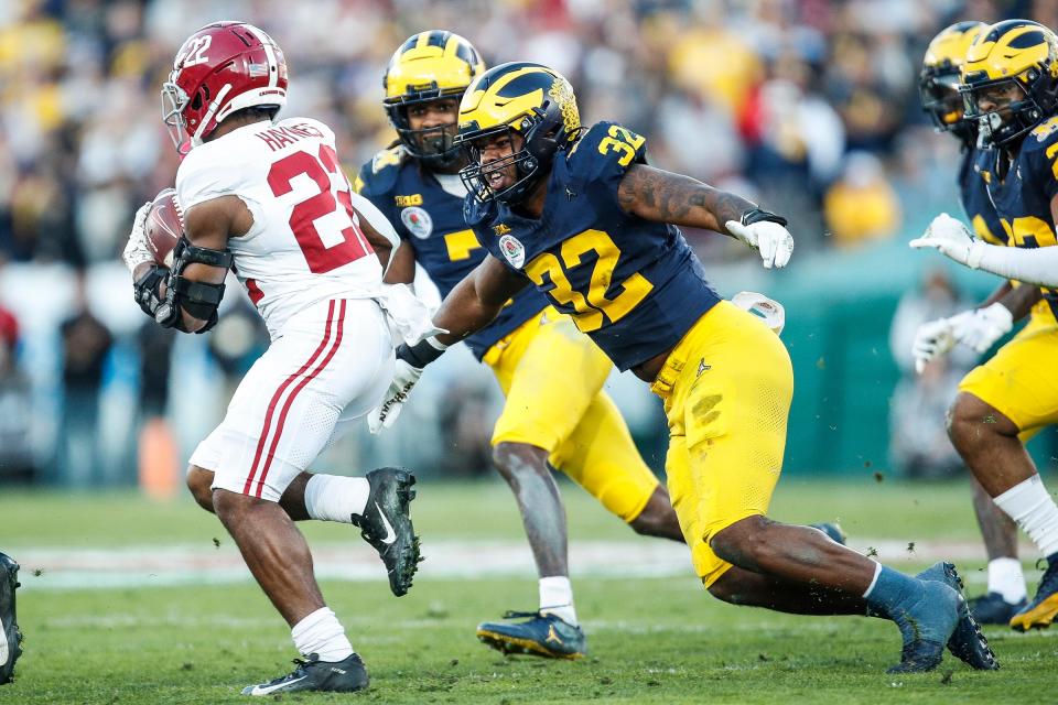 Michigan defensive end Jaylen Harrell (32) looks to tackle Alabama running back Justice Haynes (22) during the second of the Rose Bowl in Pasadena, Calif., on Monday, Jan. 1, 2024.