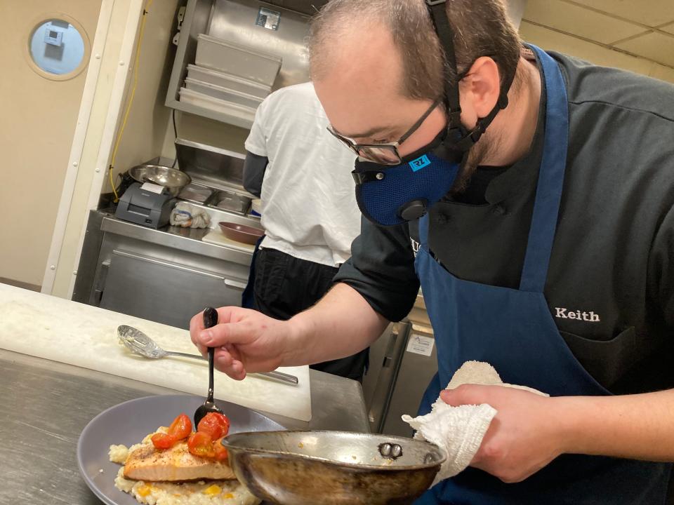 Keith Walker, chef at Hugo's Bar & Grill, plates Faroe Island salmon with roast butternut squash, risotto and preserved cherry tomato at the Montpelier restaurant Feb. 17, 2022.