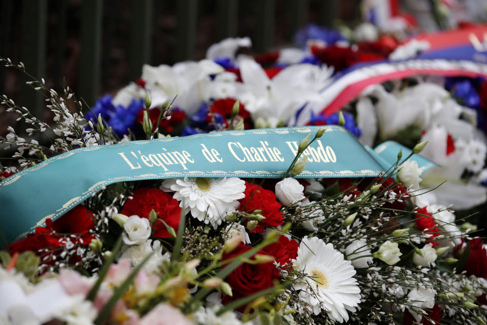 A wreath of flowers is seen outside the satirical newspaper Charlie Hebdo's former office, before a ceremony to mark the fourth anniversary of the attack in Paris, Monday, Jan. 7, 2019. 2015. Cartoonists, religious leaders and top French officials are paying respects to 17 people killed by Islamic extremists targeting satirical newspaper Charlie Hebdo and a kosher supermarket in 2015. (Gonzalo Fuentes, Pool via AP)