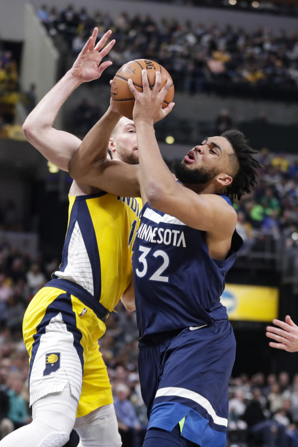 Minnesota Timberwolves center Karl-Anthony Towns (32) shoots in front of Indiana Pacers forward Domantas Sabonis (11) during the first half of an NBA basketball game in Indianapolis, Friday, Jan. 17, 2020. (AP Photo/Michael Conroy)