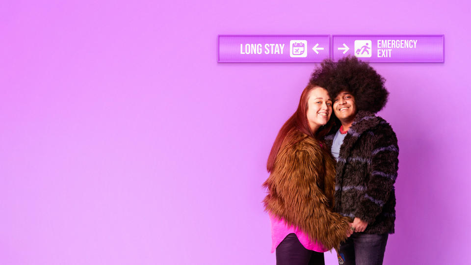 Louise and Jose against a purple backdrop