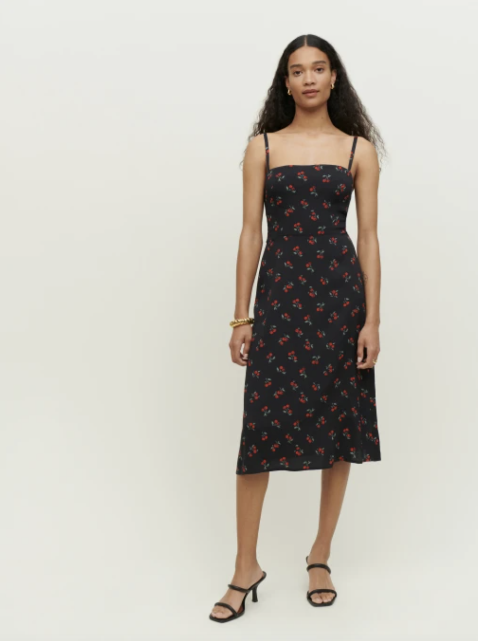 model with long black hair wearing reformation cherry print midi Afternoon Dress (Photo via Reformation)
