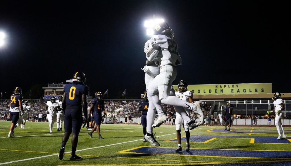 Golden Gate Titans running back Trayvon Jean (22) celebrates with quarterback Sam Powell (8) after a touchdown during the second quarter of a district game against the Naples Golden Eagles at Staver Field in Naples on Thursday, Sept. 14, 2023.