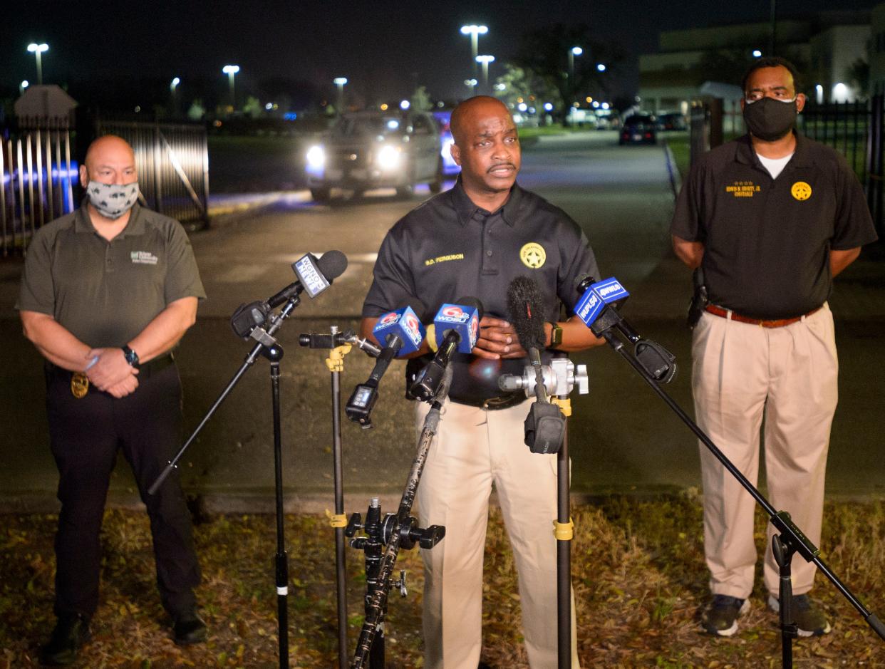 New Orleans Police Chief Shaun Ferguson, center, updates the media on the investigation of a shooting at George Washington Carver High School on 26 February 2021 (AP)