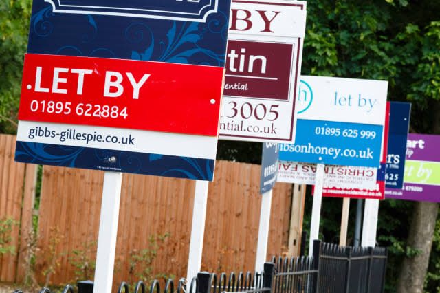 London, UK-circa 2013: Estate agent "let by" signs line the road in a suburb of London