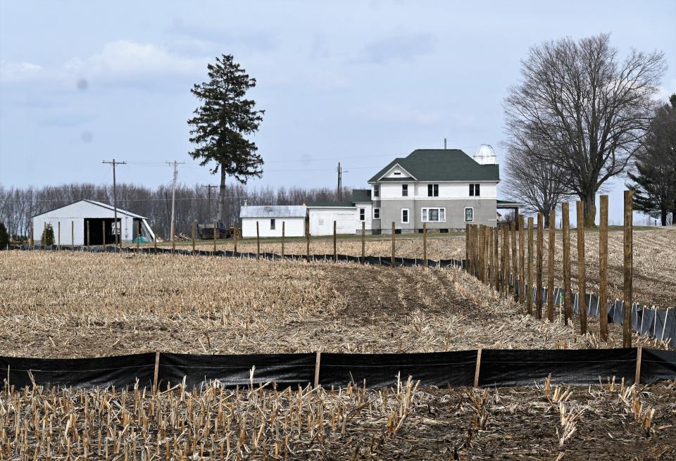 The seven-foot-high fence is going up around a participating farm owner's home west of Burlington Road for the DTE Sauk Solar Farm.