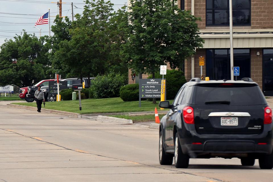 Pedestrians and vehicles mix on a stretch of Neenah's Gillingham Road that doesn't have sidewalks.