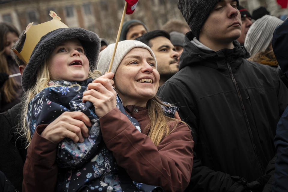 People gather to celebrate at Christiansborg Palace Square in Copenhagen, Denmark, Sunday, Jan. 14, 2024. Queen Margrethe II has become Denmark's first monarch to abdicate in nearly 900 years when she handed over the throne to her son, who has become King Frederik X. (Emil Nicolai Helms/Ritzau Scanpix via AP)