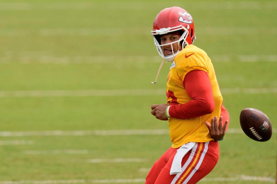Kansas City Chiefs quarterback Patrick Mahomes throws a pass behind his back during NFL football training camp Friday, Aug. 4, 2023, in St. Joseph, Mo. (AP Photo/Charlie Riedel)