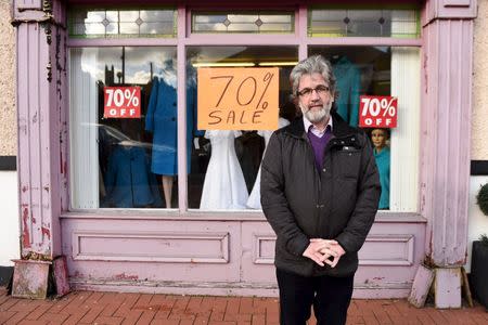 Edenderry local councillor and shop owner, John Foley, poses for a photograph in front of his shop in Edenderry, Ireland February 18, 2016. REUTERS/Clodagh Kilcoyne