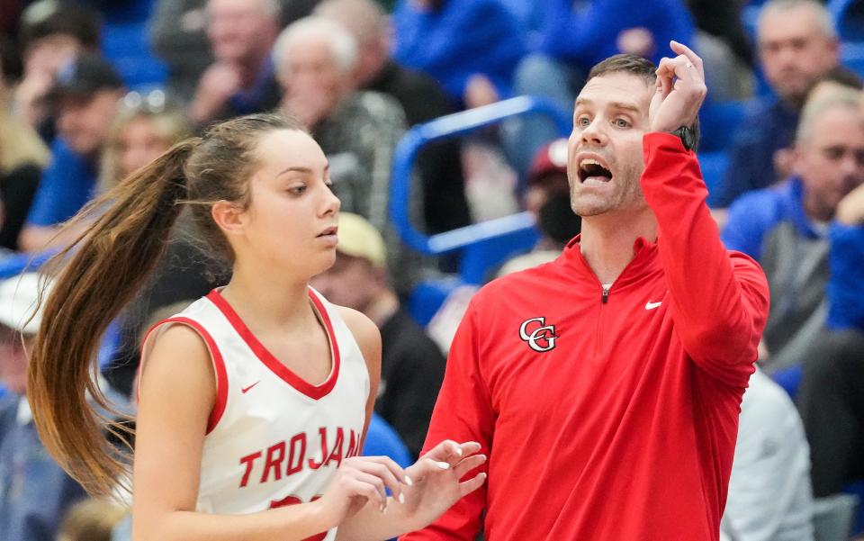 Center Grove Trojans head coach Kevin Stuckmeyer yells to players Thursday, Nov. 16, 2023, during the semifinals of the Johnson County Tournament at Franklin Community High School in Franklin. The Center Grove Trojans defeated Indian Creek, 61-52.