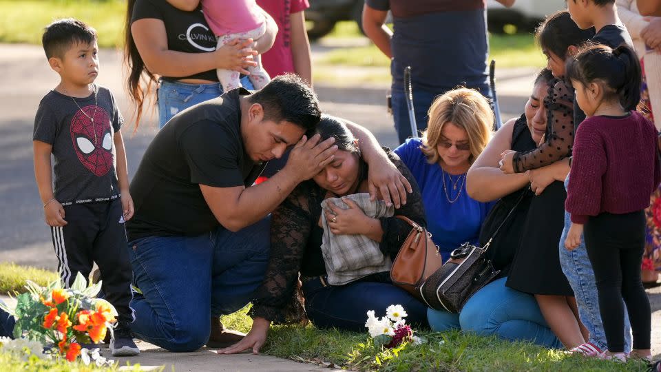 Domatilia Caal, center, is consoled by her brother, Cornelio, on Wednesday in Austin, Texas, at the site where her husband was killed in a violent trail of separate attacks on Tuesday. - Jay Janner/Austin American-Statesman/AP