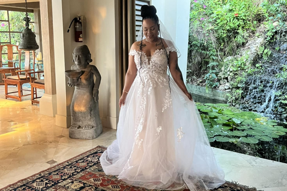 A bride modelling her white lace wedding dress