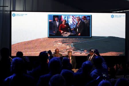 Chile's President Michelle Bachelet (C in the screen) attends the opening ceremony of the construction of The Giant Magellan Telescope (GMT) at Las Campanas hill near Vallenar town, Chile, November 11, 2015. REUTERS/Gram Slattery