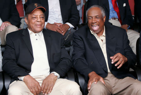 FILE PHOTO: Willie Mays (L) and Frank Robinson (R) talk at a photo session for the Major League Baseball players with over 500 career home runs before the MLB All-Star Game Home Run Derby in Houston July 12, 2004. Mays has 600 home runs and Robinson 586. REUTERS/Rick Wilking/File Photo