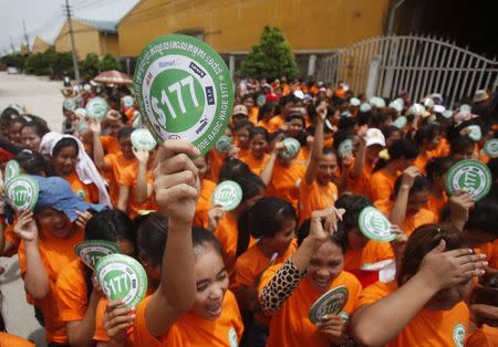 Garment workers shout and hold stickers during a protest calling for higher wages in Phnom Penh September 17, 2014. REUTERS/Samrang Pring