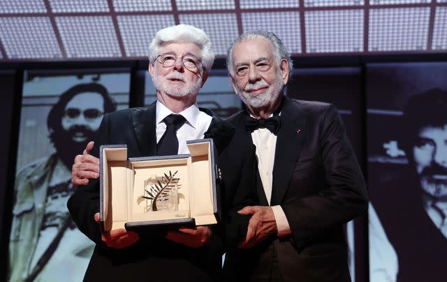 <p>Pascal Le Segretain/Getty </p> George Lucas (left) receives the Palme d'Or, presented by his longtime friend Francis Ford Coppola