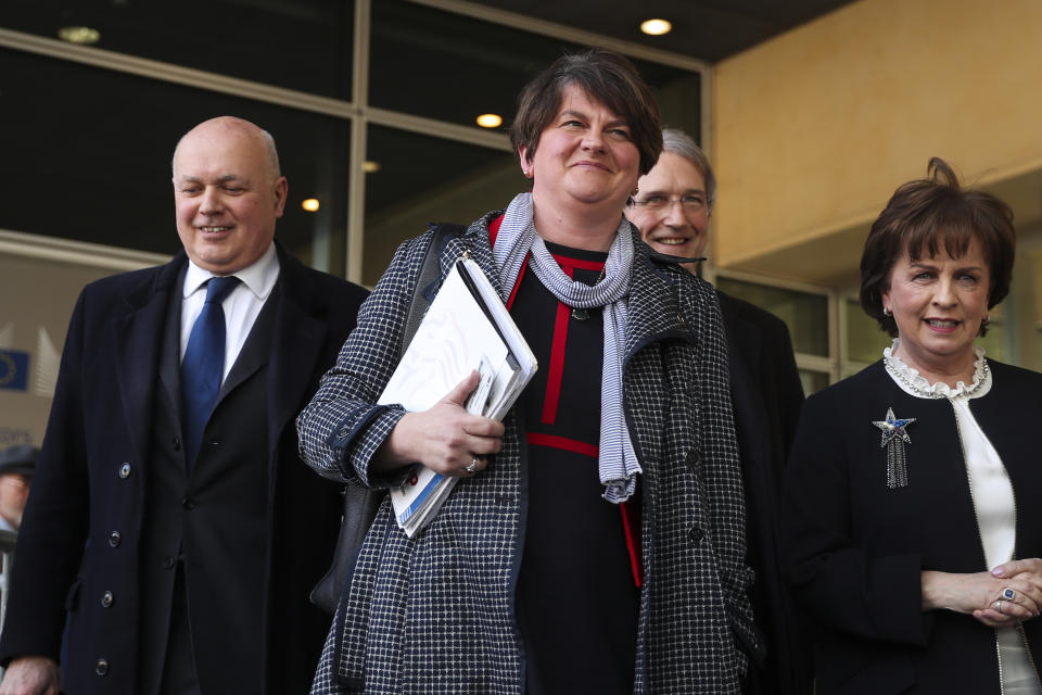 FILE - In this Thursday, April 11, 2019 file photo, Northern Ireland Democratic Unionist Party leader Arlene Foster, center, speaks to journalists after her meeting with European Union chief Brexit negotiator Michel Barnier at EU headquarters in Brussels. The Democratic Unionist Party is a small Northern Irish political grouping with an outsized Brexit role. British Prime Minister Boris Johnson most likely needs the 10 votes the party has in Parliament if he is going to have any chance in getting any Brexit deal he negotiates with the European Union over the line. Little wonder then, that the party is being courted intensely by Johnson. As things stand, it’s not clear whether the party will support any deal that emerges.(AP Photo/Francisco Seco, File)