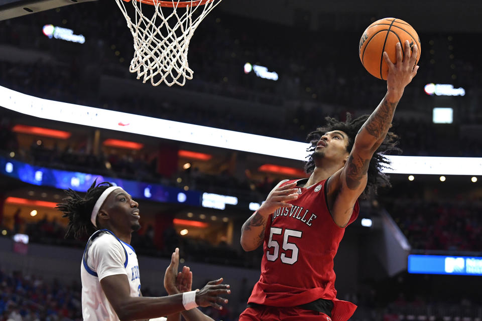 Louisville guard Skyy Clark (55) shoots next to Kentucky forward Aaron Bradshaw (2) during the second half of an NCAA college basketball game in Louisville, Ky., Thursday, Dec. 21, 2023. Kentucky won 95-76. (AP Photo/Timothy D. Easley)