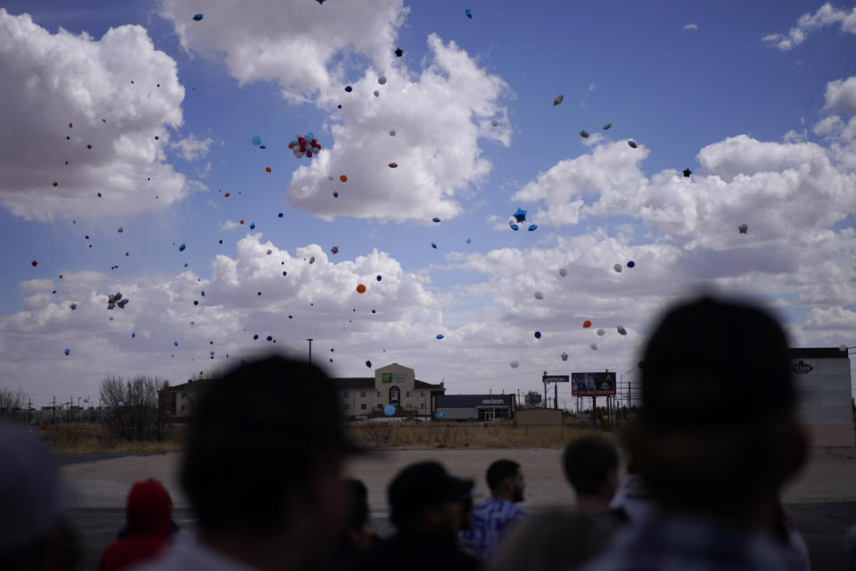 People watch after releasing balloons during a memorial for Jackson Zinn at a Texas Roadhouse restaurant, Thursday, March 17, 2022, in Hobbs, New Mexico. Zinn, who worked at the restaurant, was killed with several other student golfers and the coach of University of the Southwest in a crash in Texas. (AP Photo/John Locher)