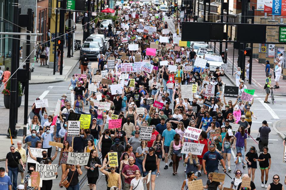 A protest that started outside the Hamilton County Courthouse marches along Walnut Street in downtown Cincinnati Friday, June 24, 2022 after The U.S. Supreme Court voted to overturn the Roe v. Wade rolling back nearly 50 years of protections for those seeking abortions.  