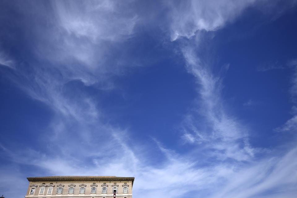 Pope Francis, second window from right, reads a message during the Angelus noon prayer from the window of his studio overlooking St.Peter's Square, at the Vatican, Sunday, Oct. 2, 2022. Pope Francis has appealed to Russian President Vladimir Putin, imploring him to "stop this spiral of violence and death" in Ukraine. The pontiff also called on Ukrainian President Volodymyr Zelenskyy to "be open" to serious peace proposals. (AP Photo/Alessandra Tarantino)