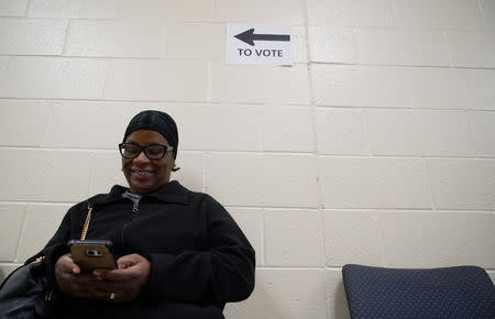 A woman waits to early-vote at the Amphitheater at Riverdale Town Center in Riverdale, Georgia, U.S., October 27, 2018. REUTERS/Lawrence Bryant