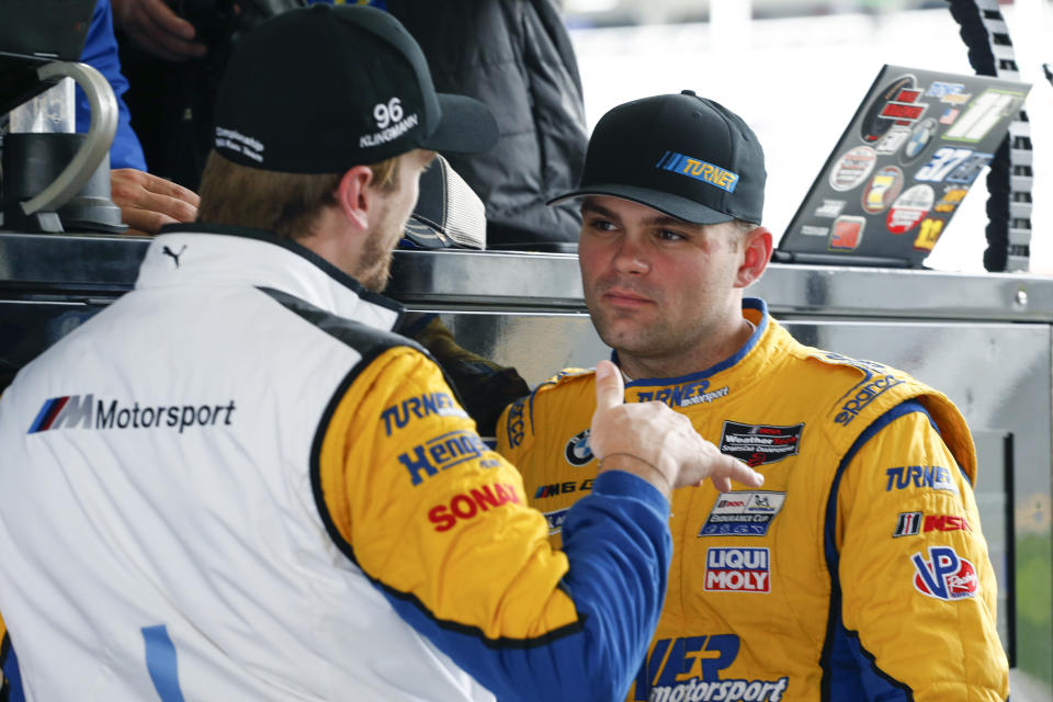 Turner Motorsports drivers Robby Foley, right, listens to fellow driver Jens Klingman in the pits during practice for the Rolex 24 hour auto race at the Daytona International Speedway, in Daytona Beach Fla., on Thursday, Jan. 23, 2020. (AP Photo/Reinhold Matay)