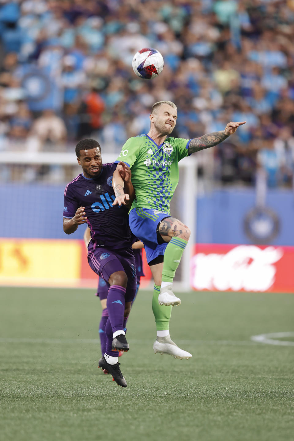 Seattle Sounders midfielder Albert Rusnák (11) battles for a jump ball with Charlotte FC defender Nathan Byrne (14) during an MLS soccer match, Saturday, June 10, 2023, in Charlotte, N.C. (AP Photo/Brian Westerholt)