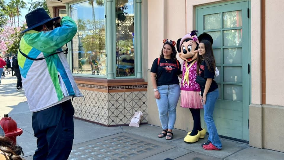 People take photos at Disney California Adventure Park on April 15. - Natasha Chen/CNN