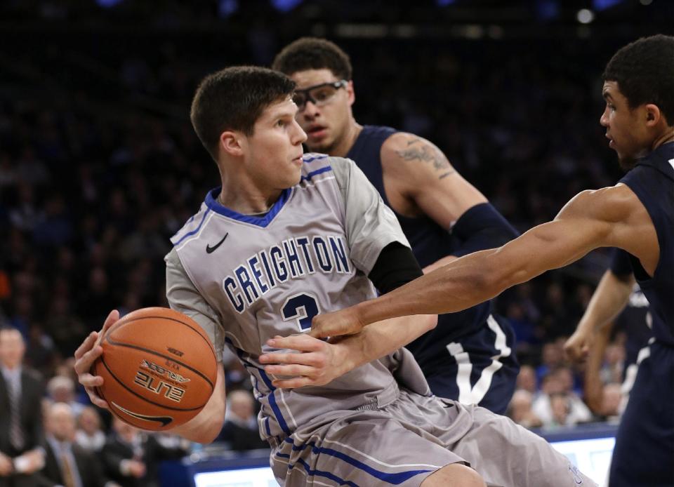 Creighton's Doug McDermott fights for control of the ball with Xavier's Dee Davis during the first half of an NCAA college basketball game in the semifinals of the Big East Conference men's tournament Friday, March 14, 2014, at Madison Square Garden in New York. (AP Photo/Frank Franklin II)