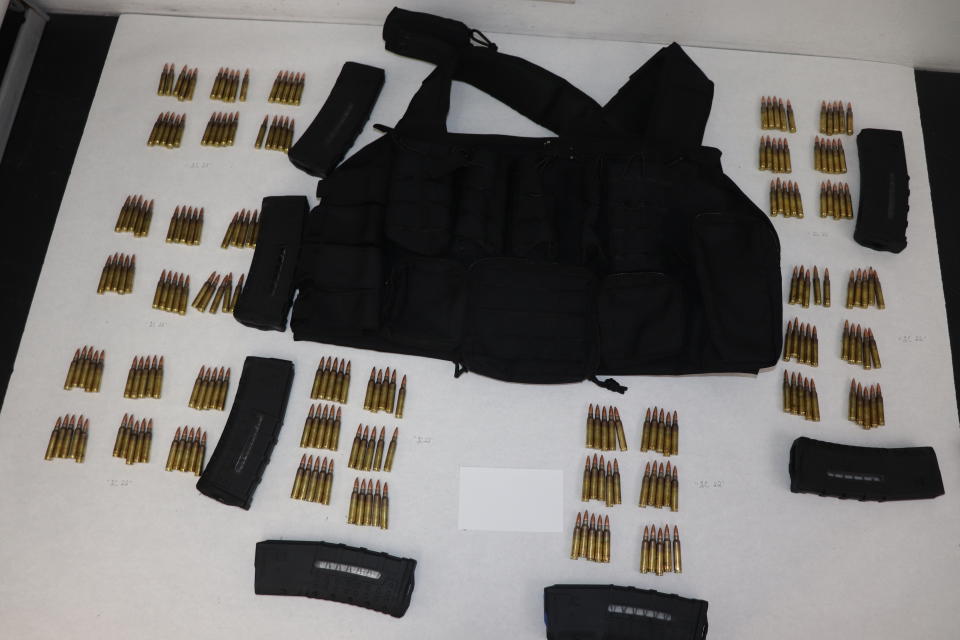 This image provided by the St. Louis Metropolitan Police Department shows ammunition, magazines and a vest used by a 19-year-old gunman who killed a teacher and a 15-year-old girl at a St. Louis high school on Monday, Oct. 24, 2022. The gunman was armed with an AR-15-style rifle and what appeared to be more than 600 rounds of ammunition, Police Commissioner Michael Sack said Tuesday, Oct. 25, 2022. (St. Louis Metropolitan Police Department via AP)