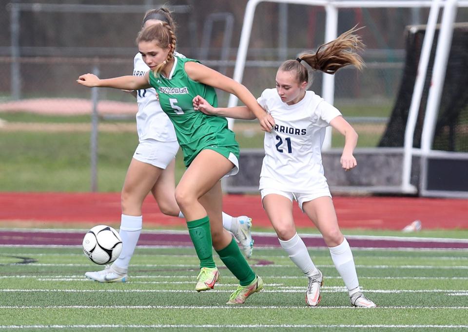 Irvington's Niki Denardo (5) moves the ball away from Lourdes' Mary Wilantewicz (21) during the girls soccer Class B state regional semifinals at Arlington High School in Lagrangeville Nov. 1, 2022. Irvington won the game 1-0 in overtime.