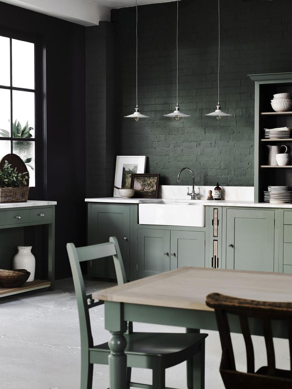 <p>All-over colour in the kitchen can often be a challenge, but this striking style from Neptune proves just how it can be done. The traditional bricked wall has been coated in a dark green, with dining room table chairs and cabinets to wonderfully match. </p><p> <strong>READ MORE:</strong> <a href="https://www.housebeautiful.com/uk/decorate/kitchen/a23569477/kitchen-colour-ideas/" rel="nofollow noopener" target="_blank" data-ylk="slk:7 kitchen colour ideas;elm:context_link;itc:0;sec:content-canvas" class="link ">7 kitchen colour ideas</a></p><p>• Shop the look at <a href="https://www.neptune.com/" rel="nofollow noopener" target="_blank" data-ylk="slk:Neptune;elm:context_link;itc:0;sec:content-canvas" class="link ">Neptune</a></p>