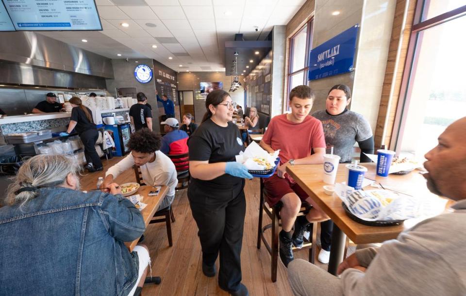 Customers enjoyed a free lunch during the grand opening of the Nick the Greek restaurant in Riverbank, Calif., Tuesday, September 12, 2023. Andy Alfaro/aalfaro@modbee.com