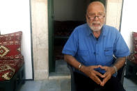 74-year-old Algerian artist Rachid Koraïchi poses for a photo, in Tunis, Wednesday June 16, 2021. A newly sanctified cemetery for Tunisia's migrant dead is filling quickly. Rachid Koraïchi bought the plot of land in the port city of Zarzis a few years ago and started designing what he hoped would be the final resting place for people who died on the move. (AP Photo/Mehdi El Arem)